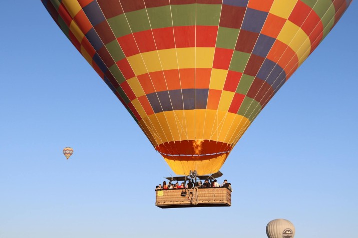 Experience a breathtaking balloon ride over Cappadocia's fairy chimneys and valleys at sunrise, book now for an unforgettable adventure in Turkey