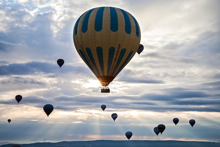 Experience the magic of a hot air balloon ride in Cappadocia, floating over fairy chimneys and valleys at sunrise, a must-do adventure for travelers